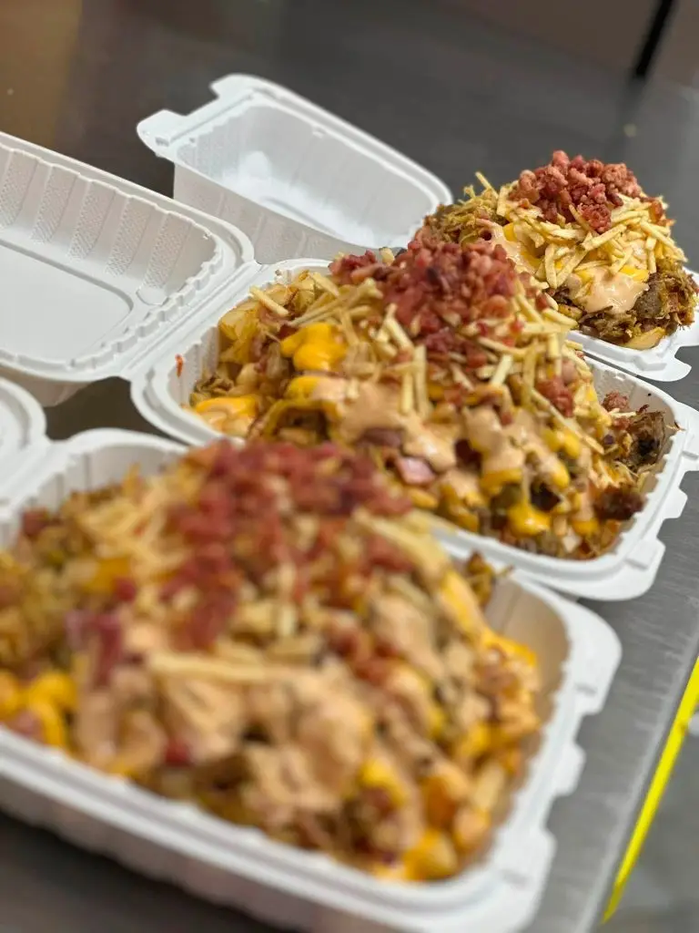 Loaded fries topped with cheese sauce and shoestring potatoes