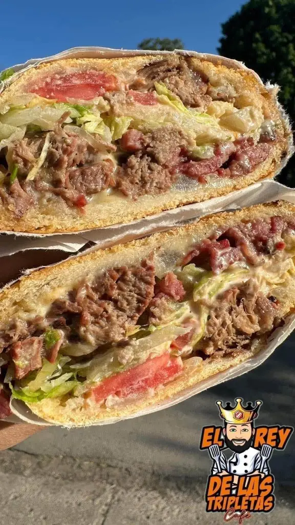 Overstuffed tripleta sandwich with El Rey de las Tripletas Café logo